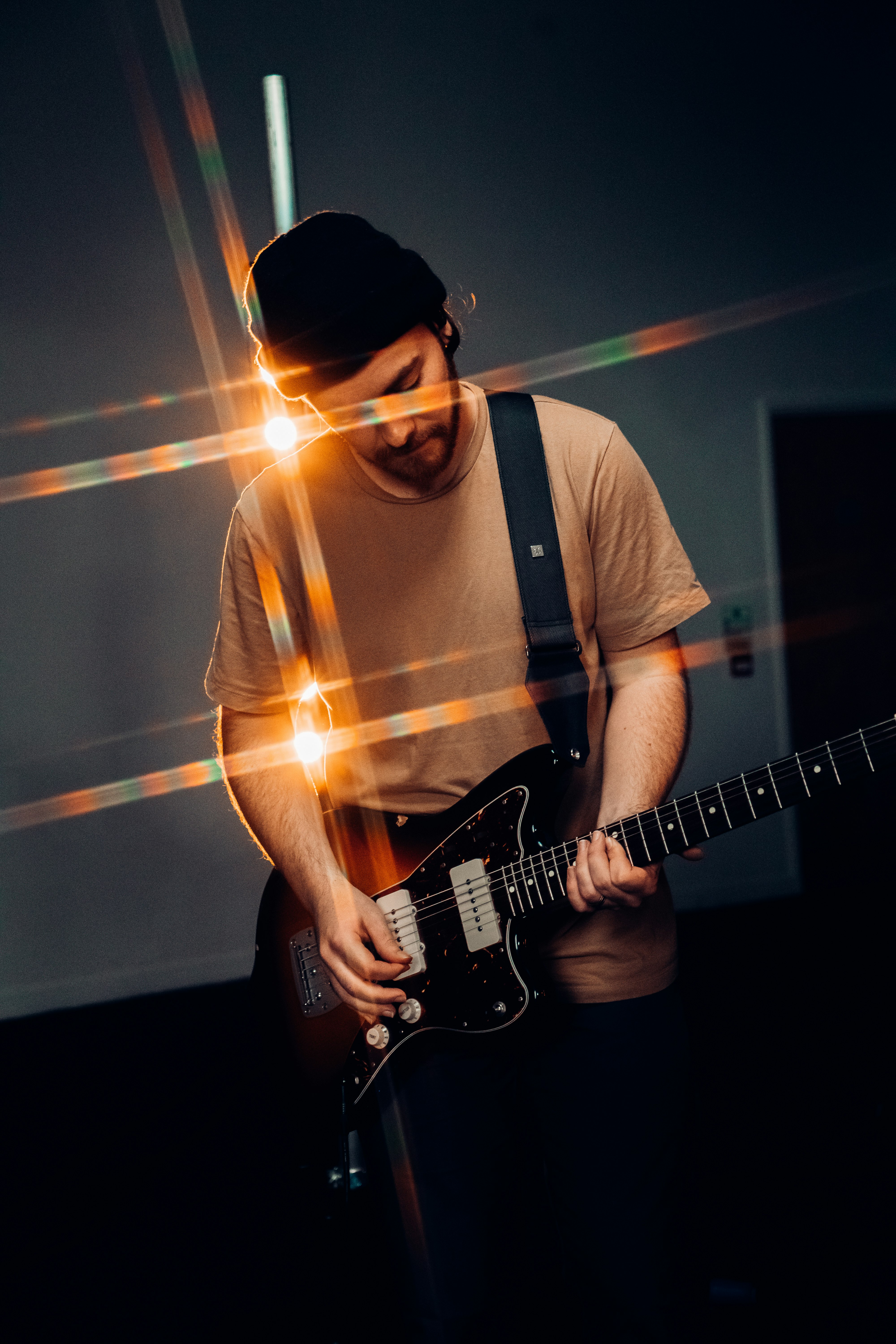 man in white crew neck t-shirt playing electric guitar